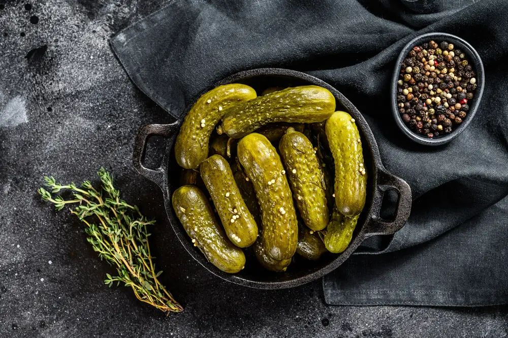 A pickle is a vegetable that has been preserved in brine (a salty solution made by combining water and salt). It is often used as a condiment or flavoring in foods.